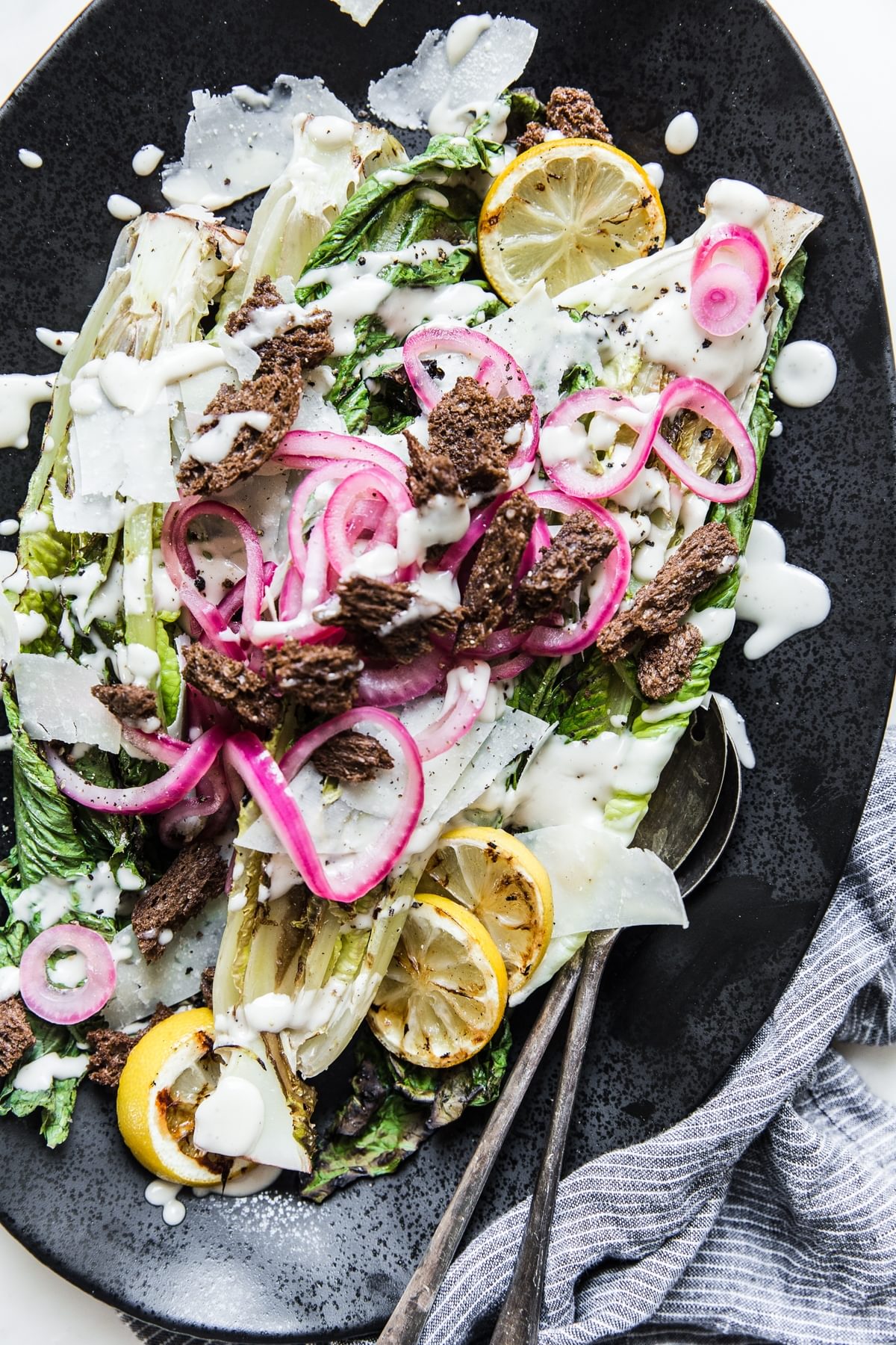 Grilled Romaine Caesar Salad with pickled onion croutons and lemons
