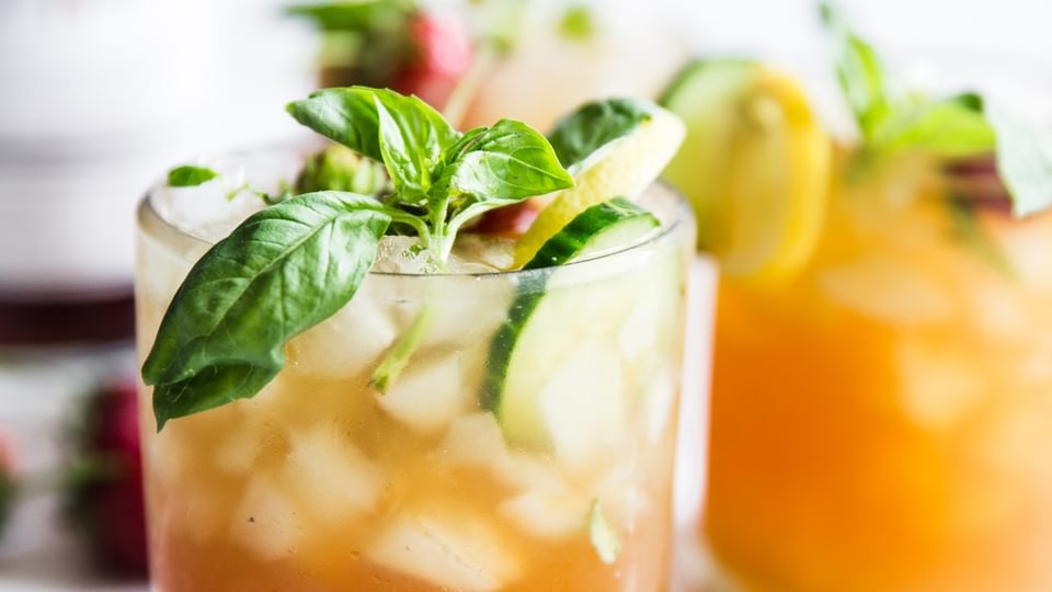 Pimm's Cup cocktail with strawberries, cucumber and basil