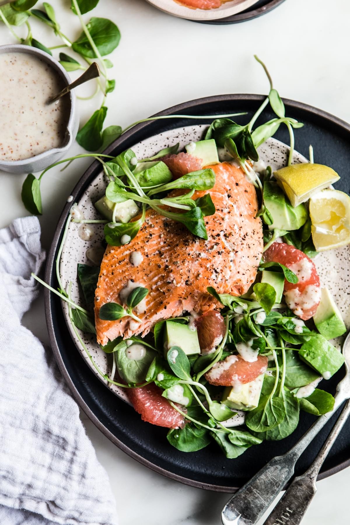 salmon and grapefruit salad with honey mustard dressing styled on a plate