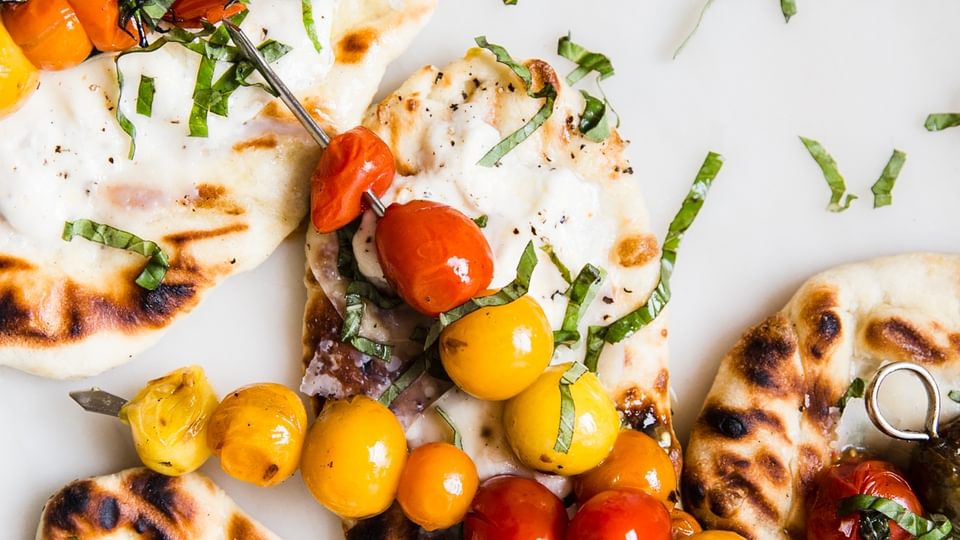 grilled flatbread with burrata cheese, tomatoes and basil