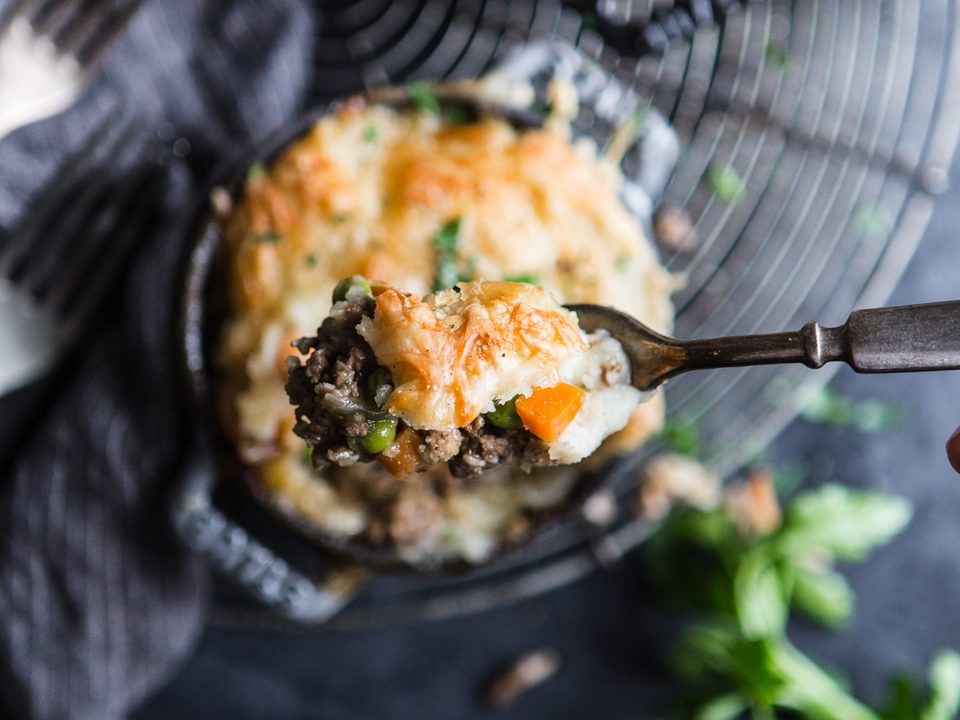 lamb shepherd's pie with puff pastry peas and carrots.