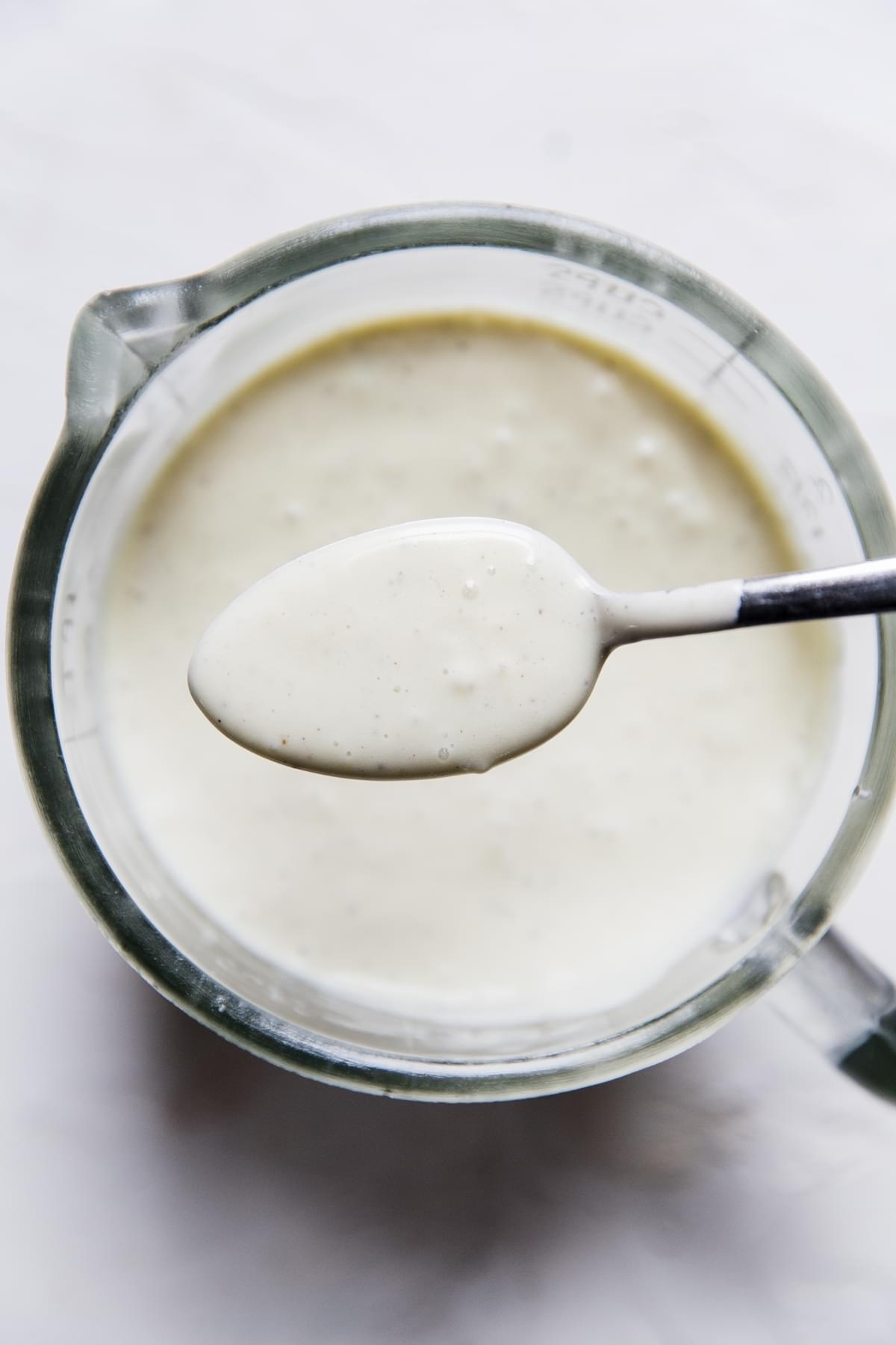 creamy goat cheese dressing in a jar with a spoon