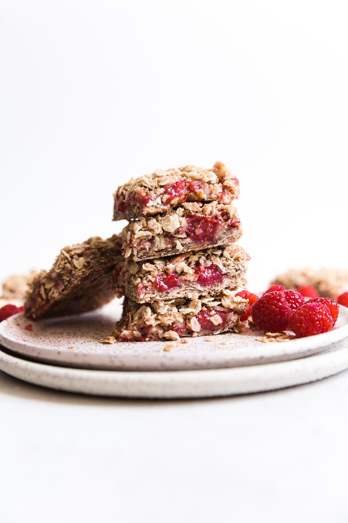 Raspberry coconut salmon oat bars stacked on a plate