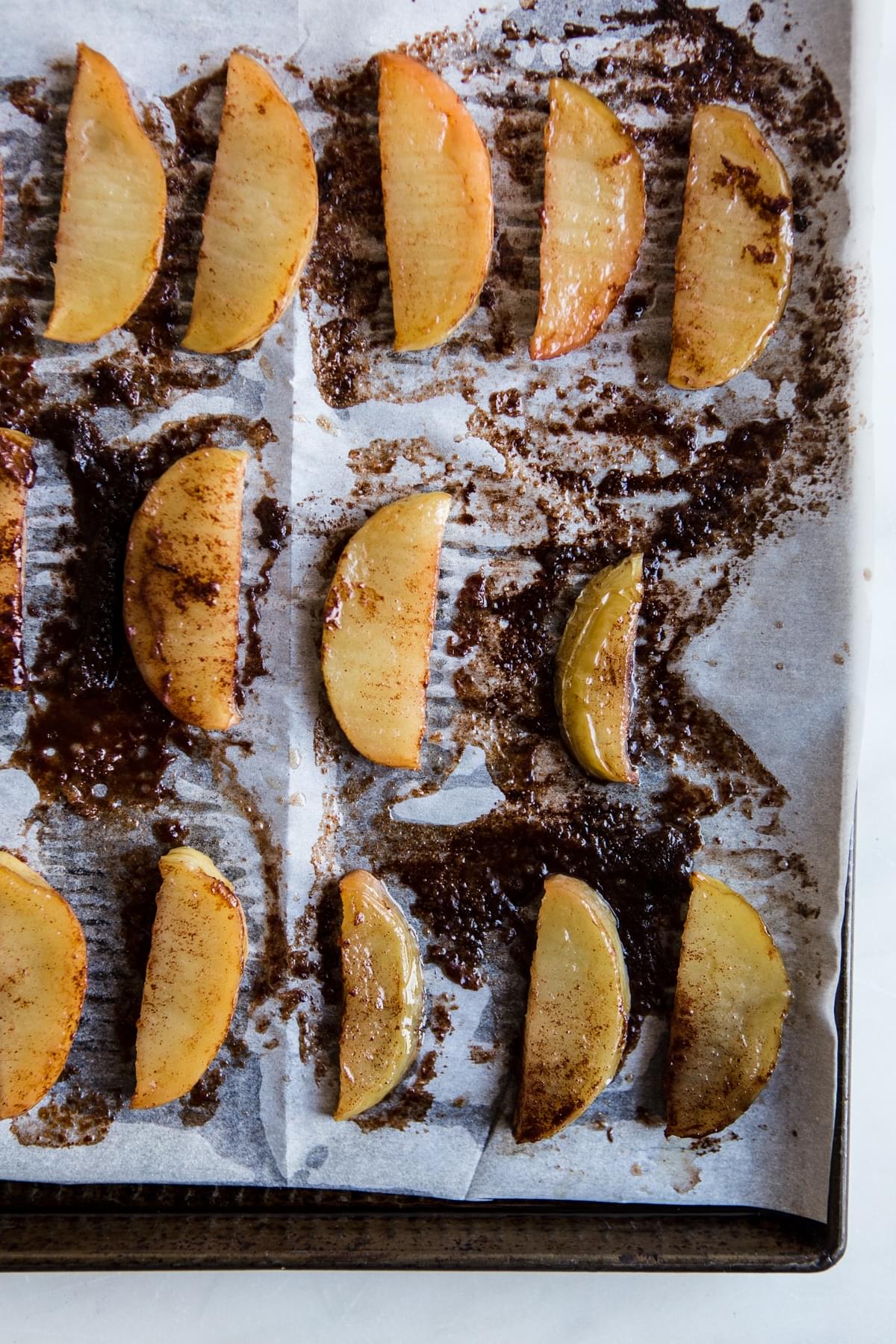 apple slices baked with butter and brown sugar on a sheet pan