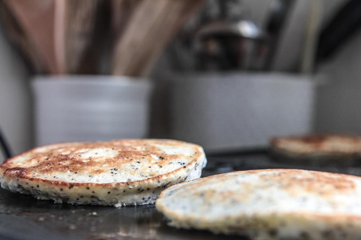 almond poppy seed pancakes on a pancake griddle