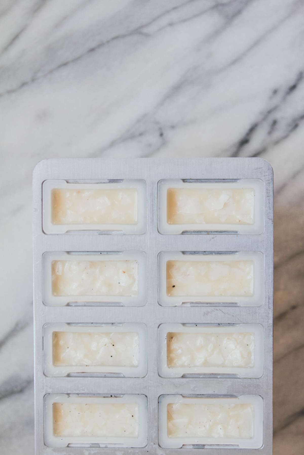 Coconut Cream Popsicles With Vanilla Bean And Malibu Rum in a popsicle mold