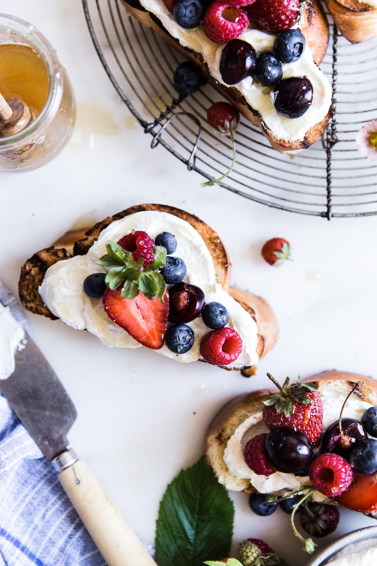 toasted Challah bread with honey, cherries, strawberries, raspberries, blueberries, mascarpone, greek yogurt