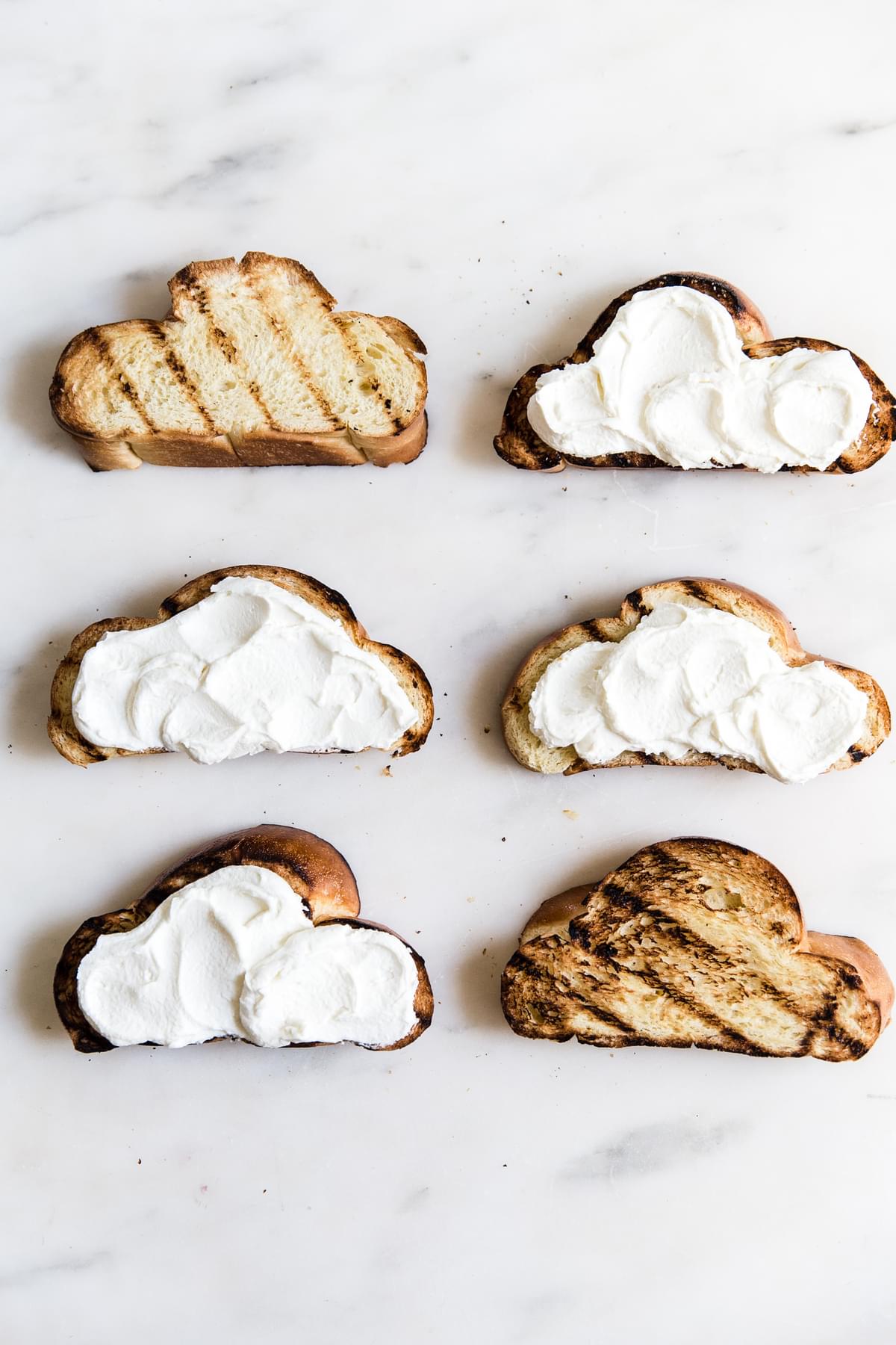 6 slices of Grilled Challah bread with whipped mascarpone and yogurt spread on it