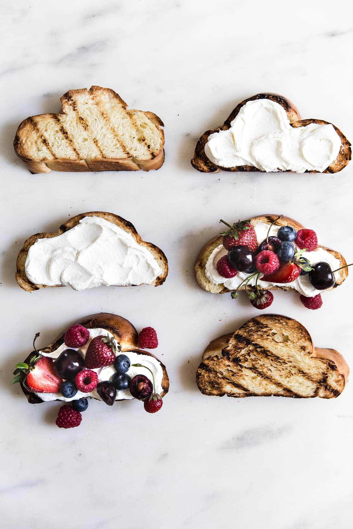 6 grilled challah bread slices with mascarpone and yogurt spread topped with fresh berries