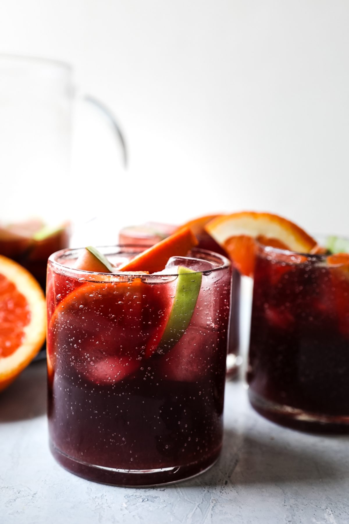 homemade sangria recipe in cups with apples and oranges