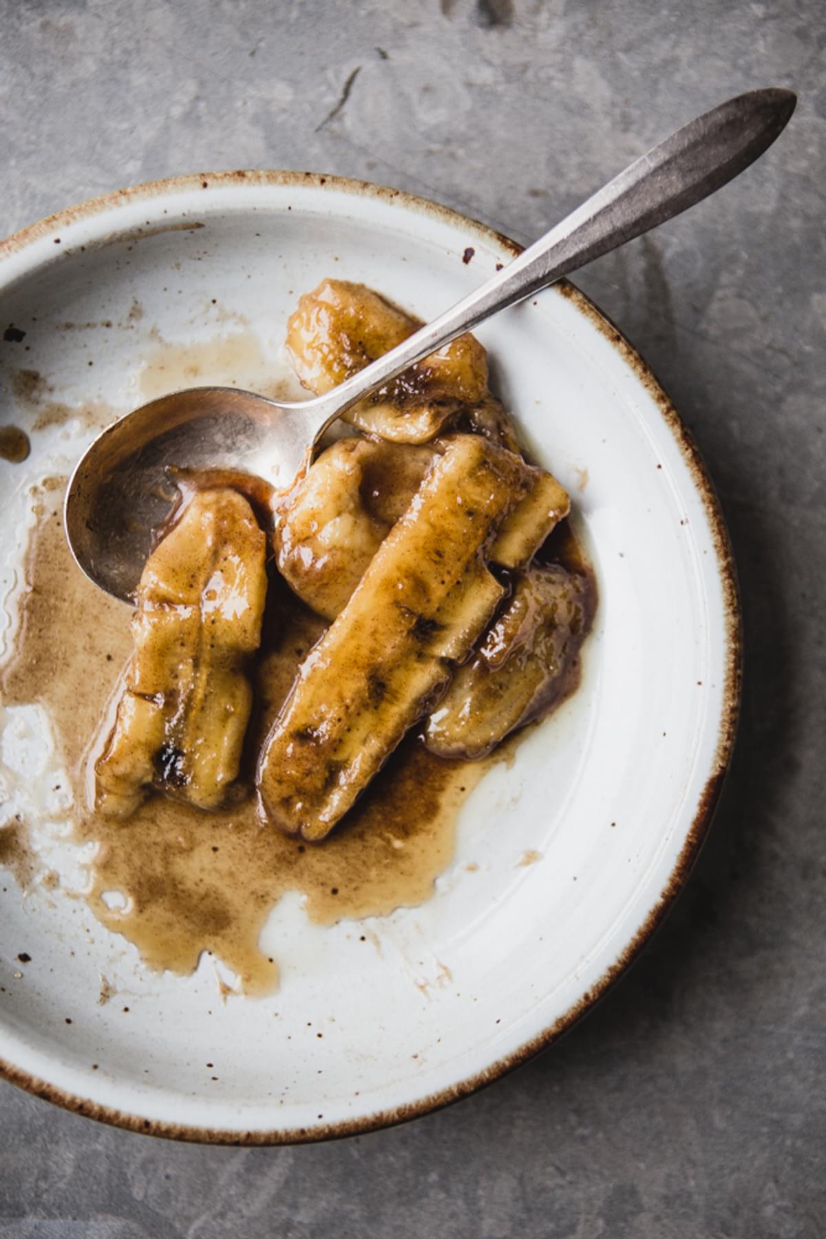 Caramelized Bananas on a plate with a spoon