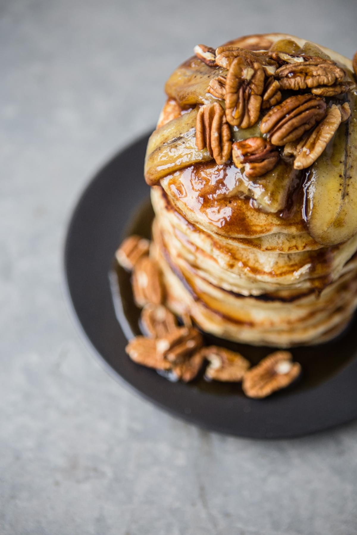 a plate of Pancakes with Caramelized Bananas and Toasted Pecans