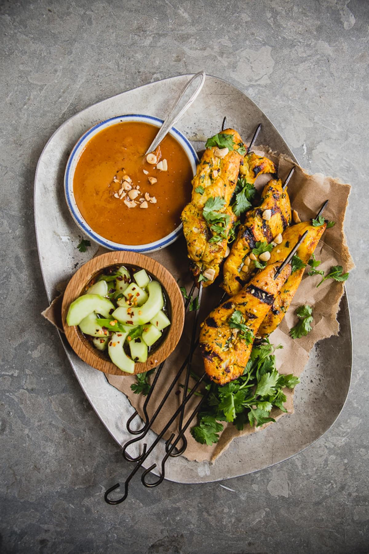 grilled Chicken Satay on skewers served with Peanut Sauce and Cucumber Salad