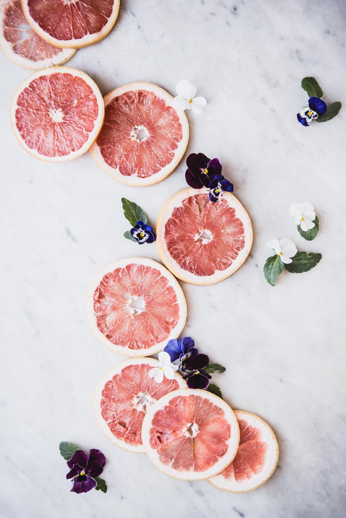 grapefruit slices and pansy flowers