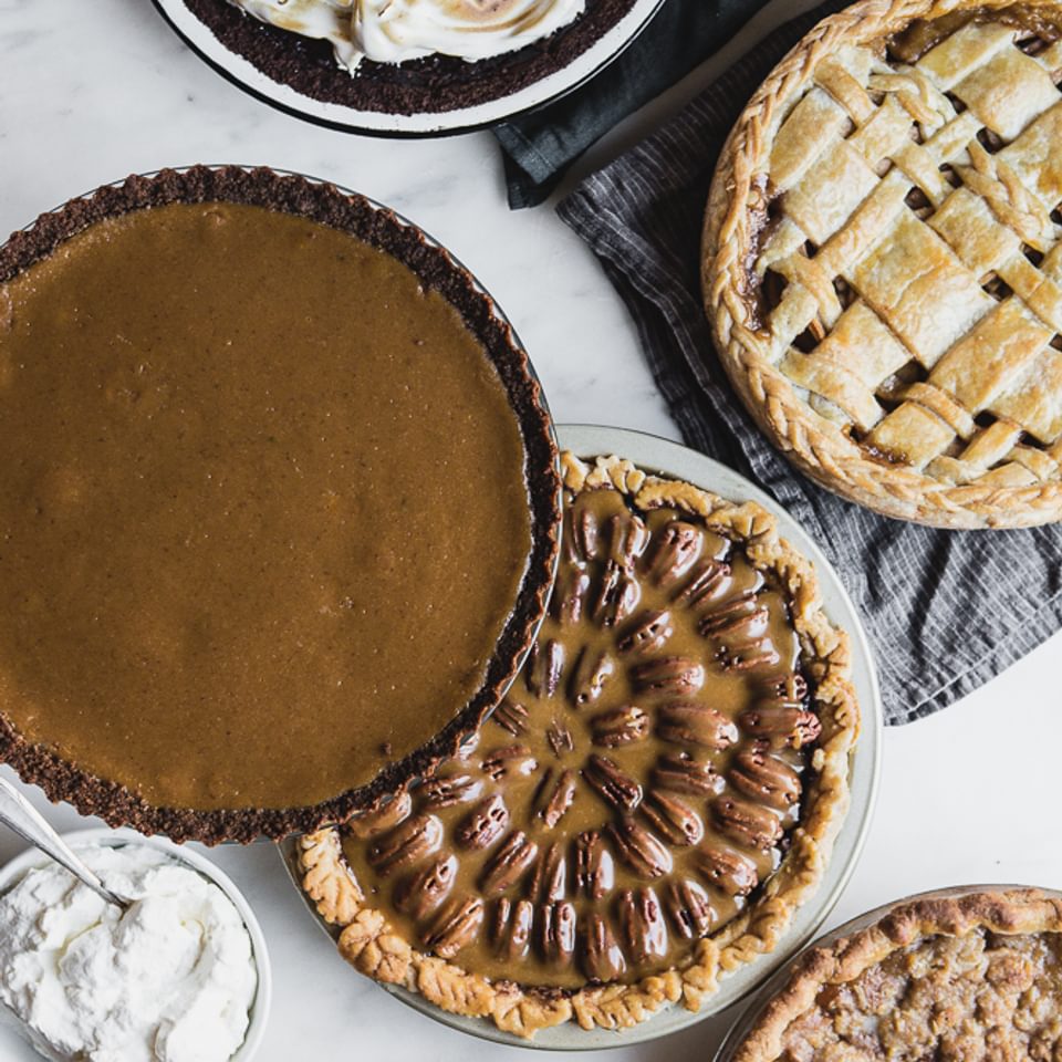 5 Thanksgiving pies on the table: pecan pie, apple pie, pumpkin pie