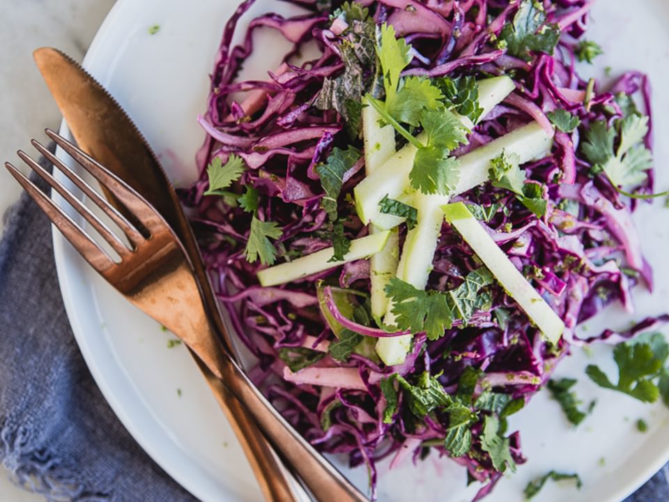 Red Cabbage and Apple Slaw on a plate with a fork