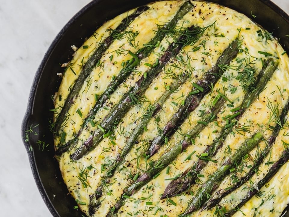 Spring Asparagus Frittata With Crème Fraîche in a cast iron pan