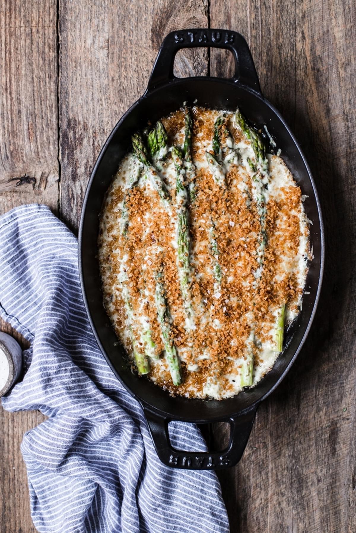 Asparagus Gratin topped with béchamel sauce, shredded Gruyère cheese & buttery Panko in a small baking dish