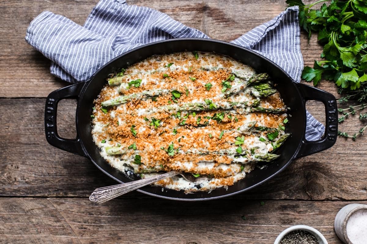 Asparagus Gratin topped with béchamel sauce, shredded Gruyère cheese & buttery Panko in a small baking dish