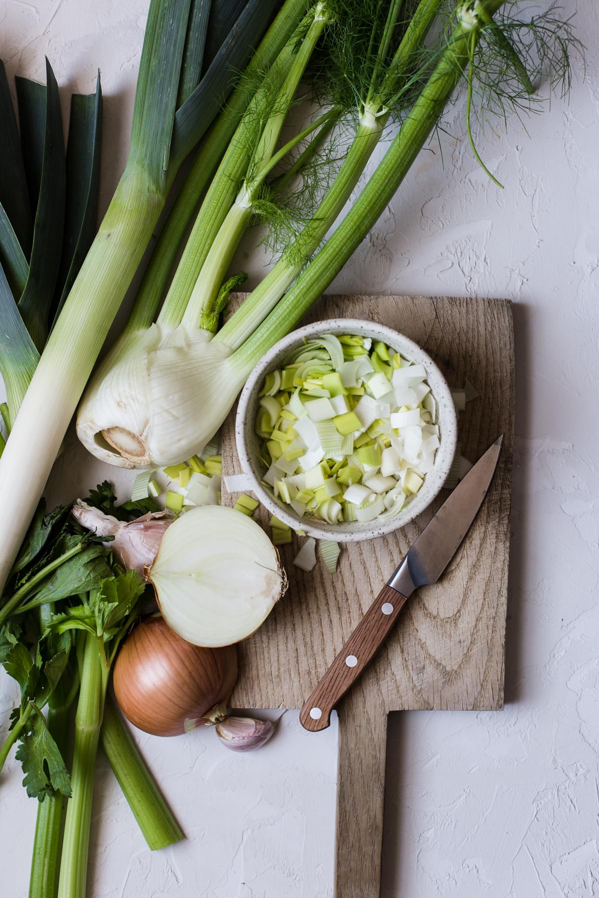 Leeks, fennel, onion and celery chopped in a bowl for bourride soup