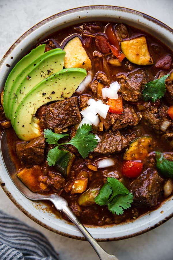 crockpot paleo chili in a bowl made with chuck roast, ground beef, zucchini and topped with avocado and cilantro