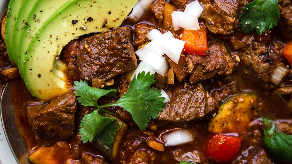 crockpot paleo chili with beef and zucchini and avocado in a bowl