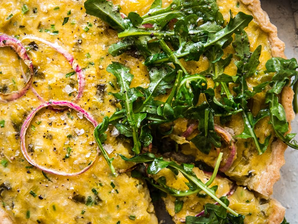 Tart made with chives, red onions, leeks, topped with Arugula Salad