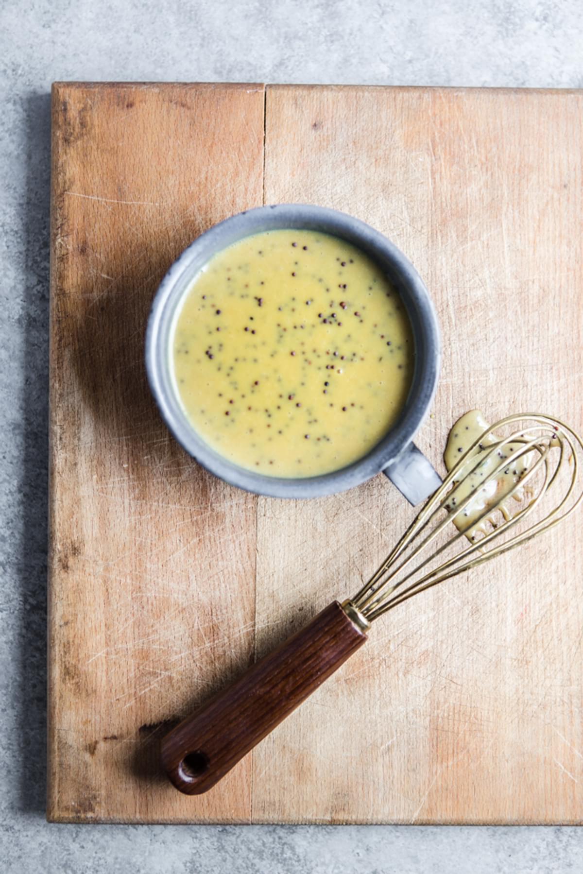 Honey Mustard dressing in a bowl and a Wisk