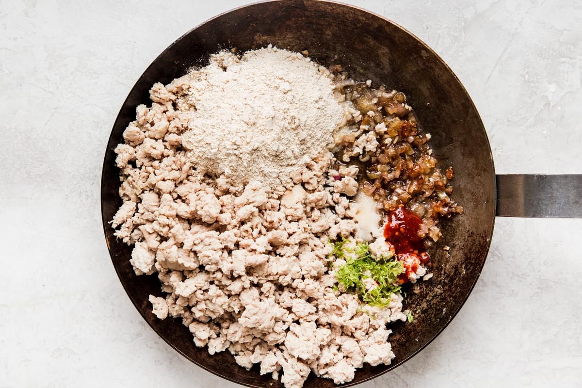 ground chicken, taosted rice powder, chili paste, shallots and lime zest in a pan