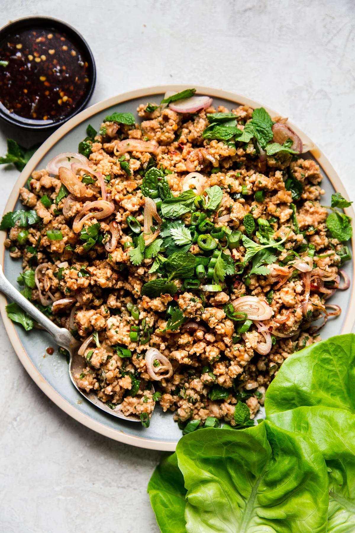 Larb Lettuce Cups on a plate with butter lettuce and sauce