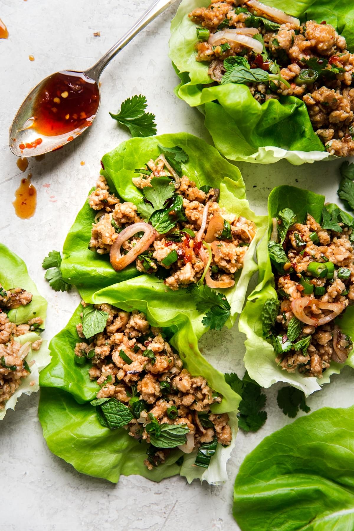 Thai Larb Lettuce Cups with sauce on a spoon