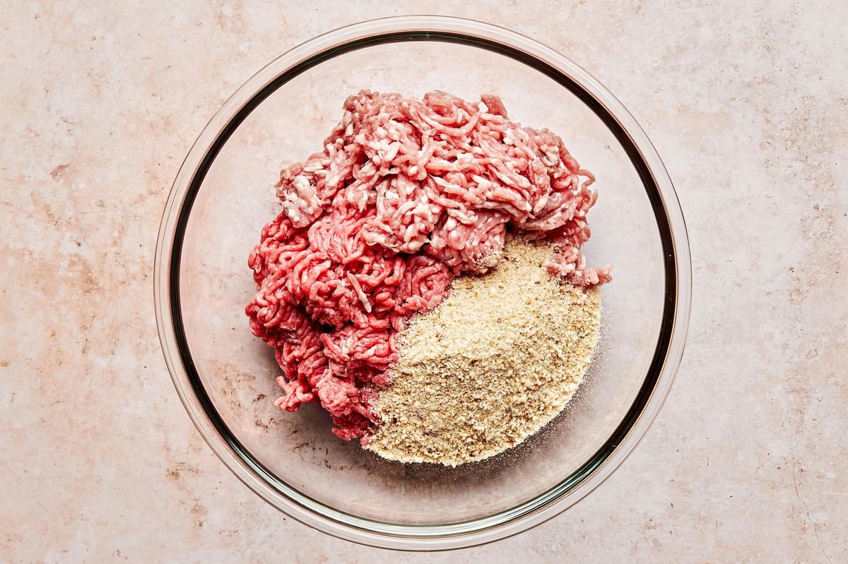 ground beef, ground pork, and breadcrumbs combined in a large mixing bowl to make mini meatloaf