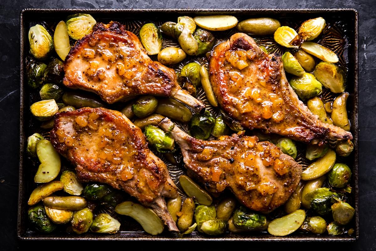 apricot glazed pork chops, roasted potatoes and brussels sprouts sheet pan dinner