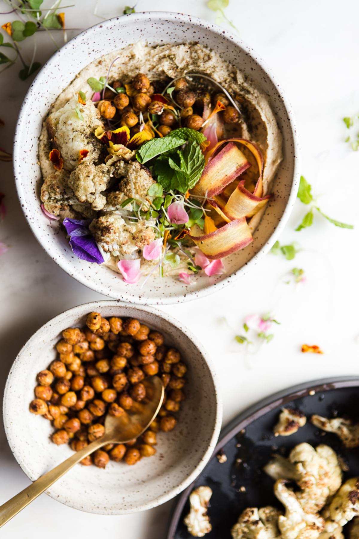 Roasted Cauliflower and Hummus Bowl with carrot ribbons, mint and crispy chickpeas