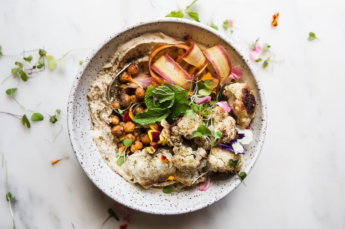 Roasted Cauliflower and Hummus Bowl with carrot ribbons, mint and crispy chickpeas