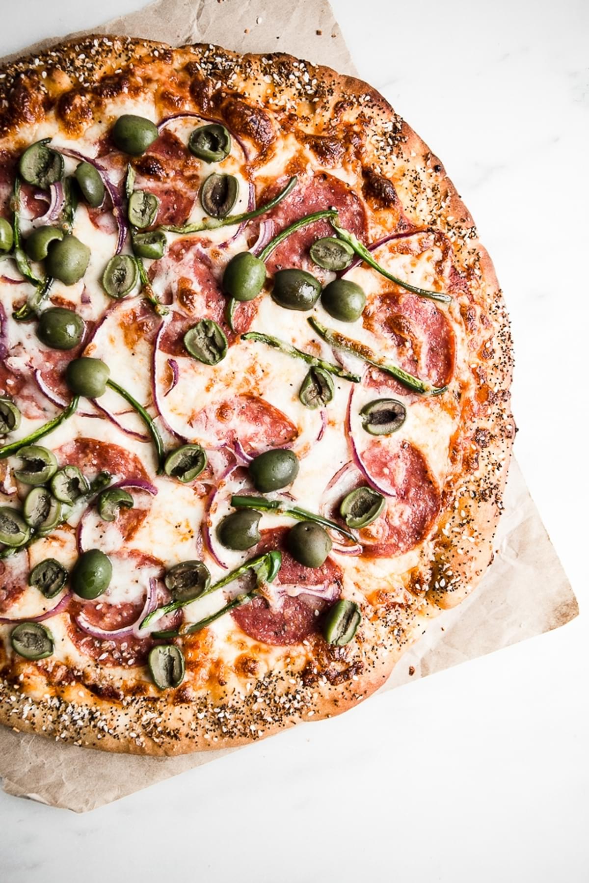 Salami, Jalapeño & Olive Pizza with Honey, jalapeños, red onions and everything bagel crust