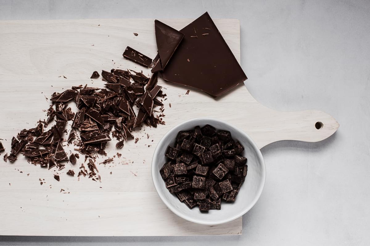 chopped up dark chocolate on a cutting board