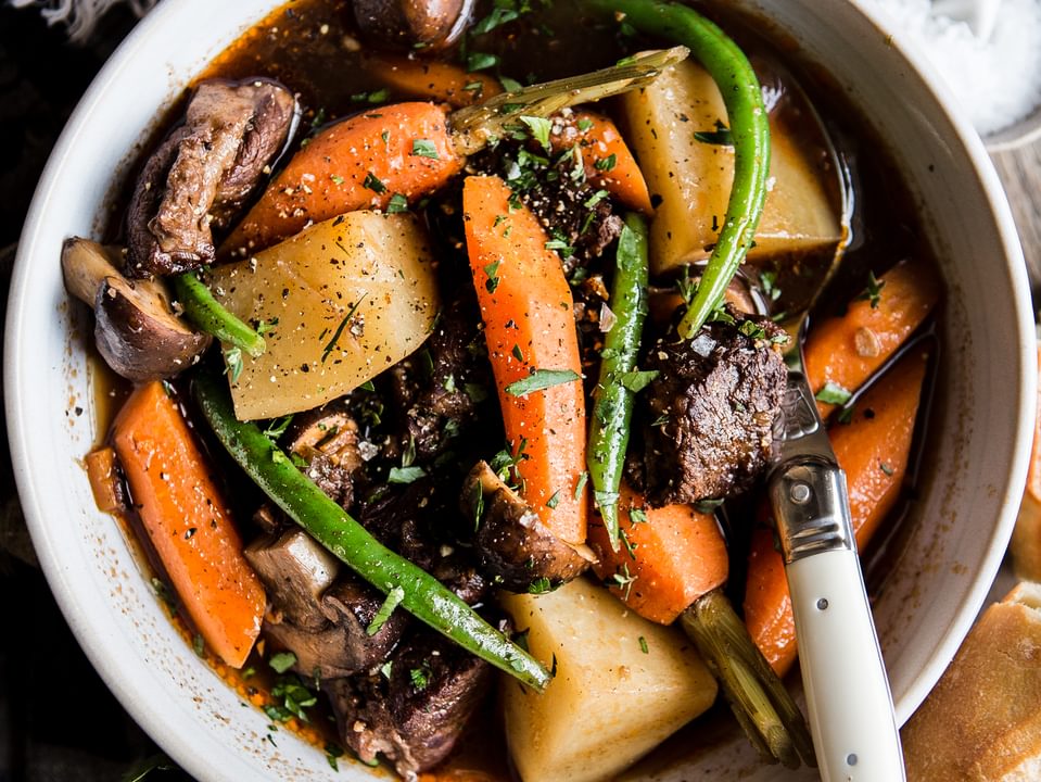 Slow Cooker Beef Stew in a bowl with carrots, green beans, mushrooms and potatoes