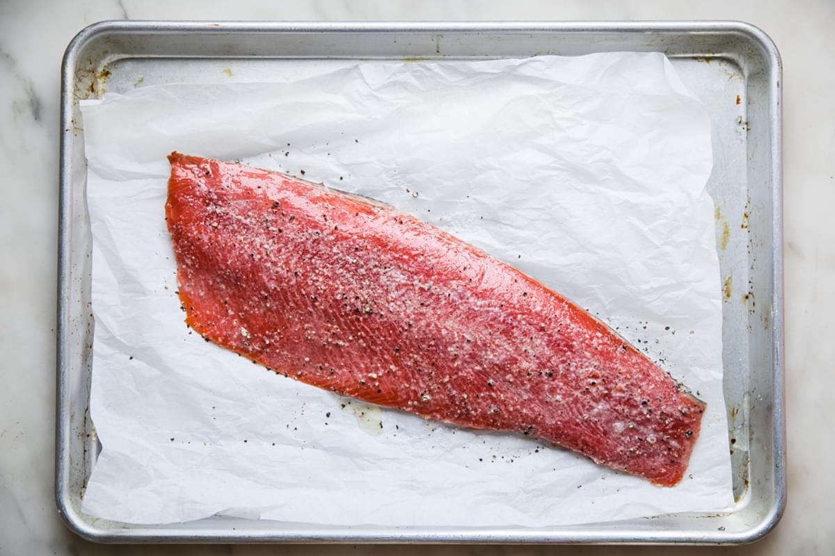salmon fillet on a rimmed baking sheet with parchment