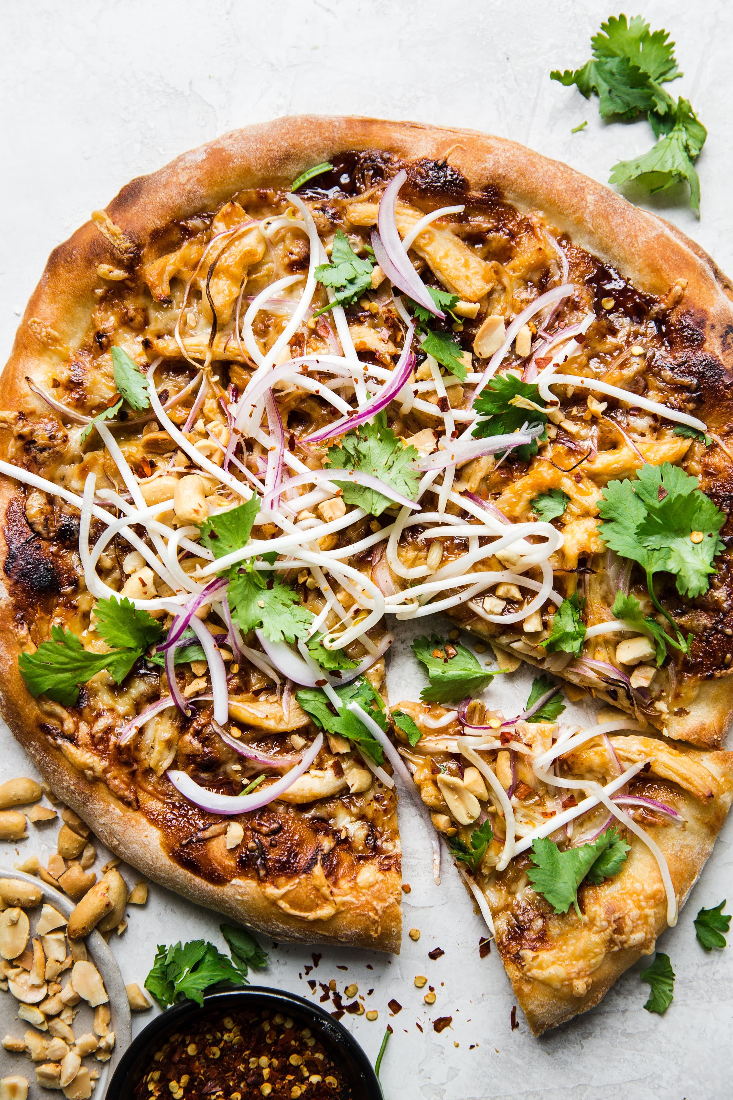 Thai Chicken pizza with cilantro, onions and peanut hoisin sauce
