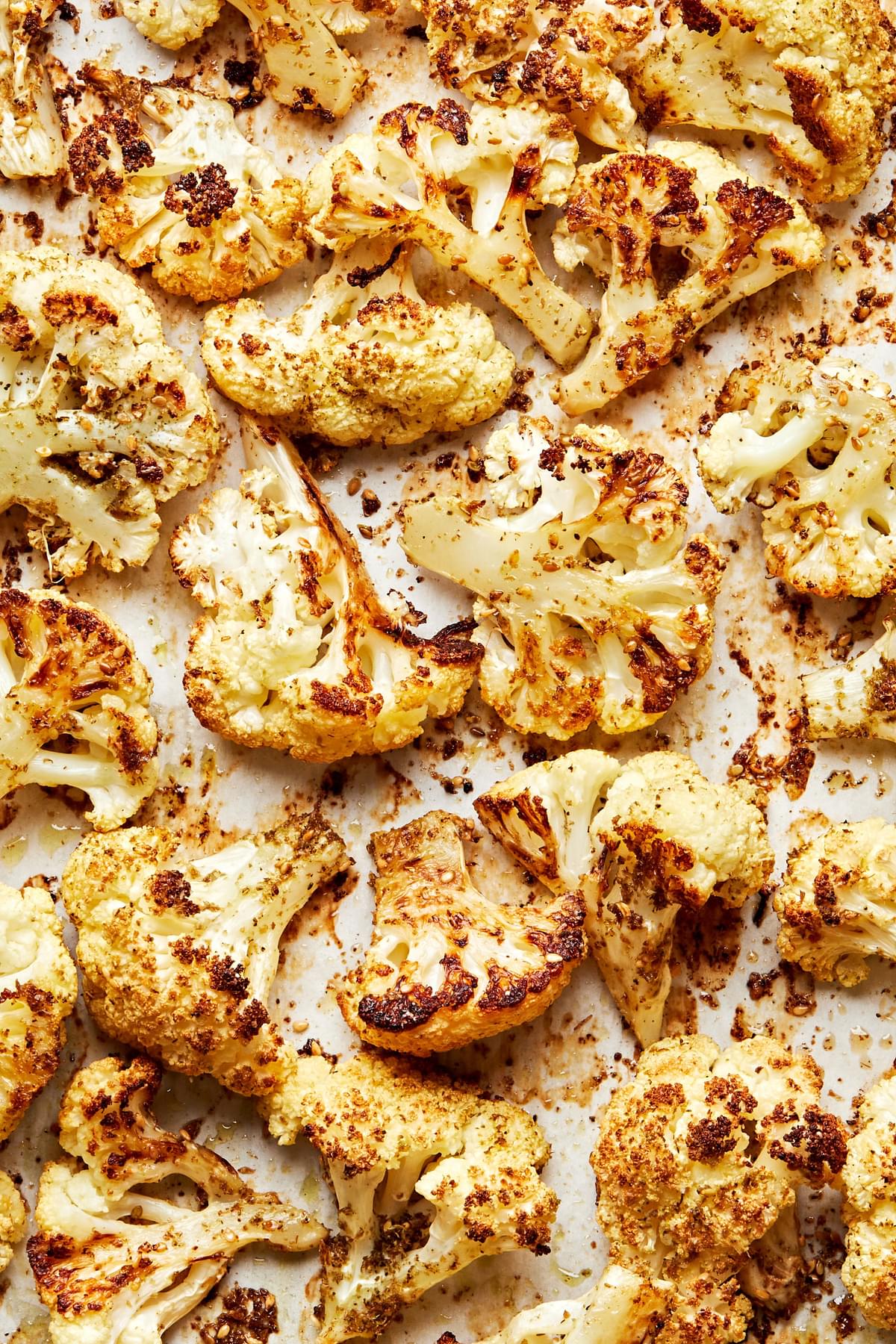 roasted cauliflower on a baking sheet tossed with olive oil, salt and za'atar spice