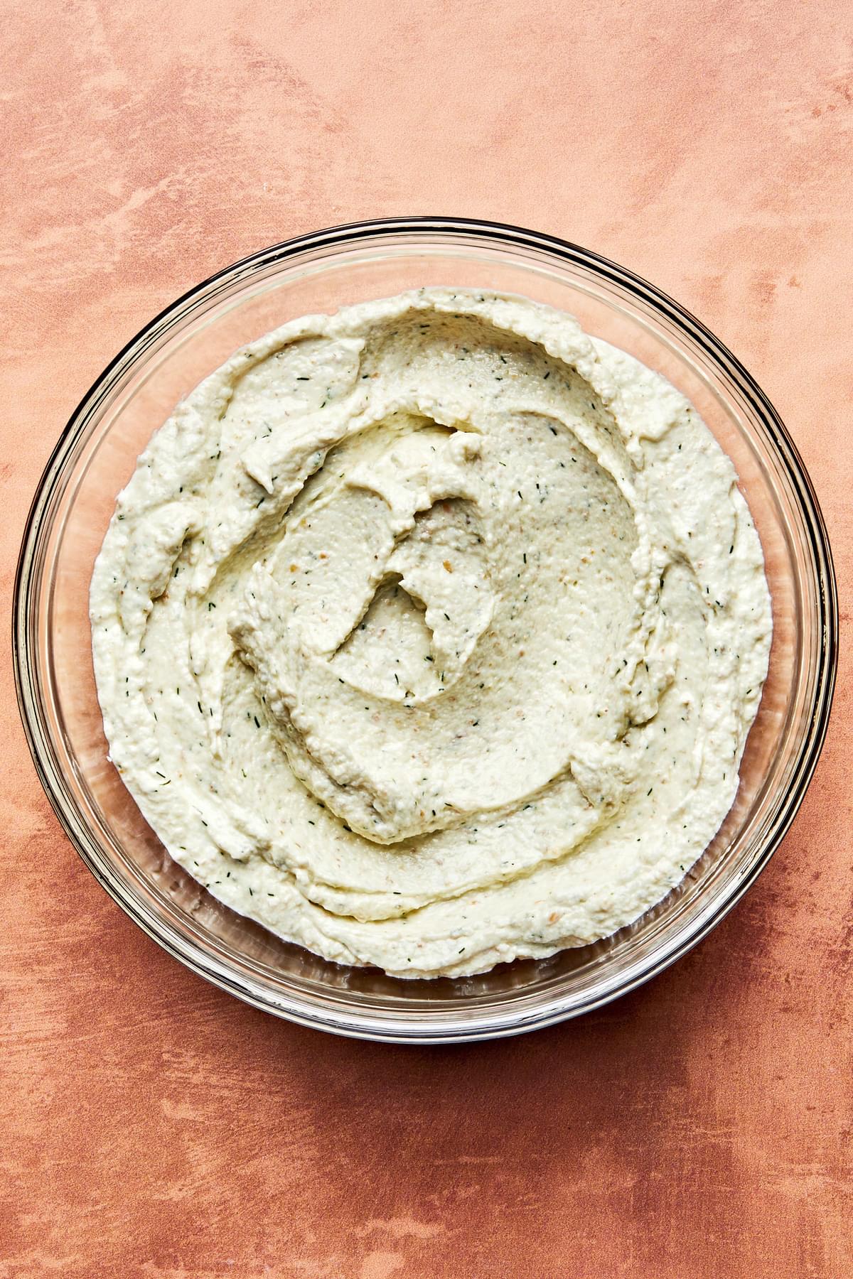 herb whipped feta in a bowl made with feta, cream cheese, garlic, dill, Za’atar, olive oil, and lemon juice