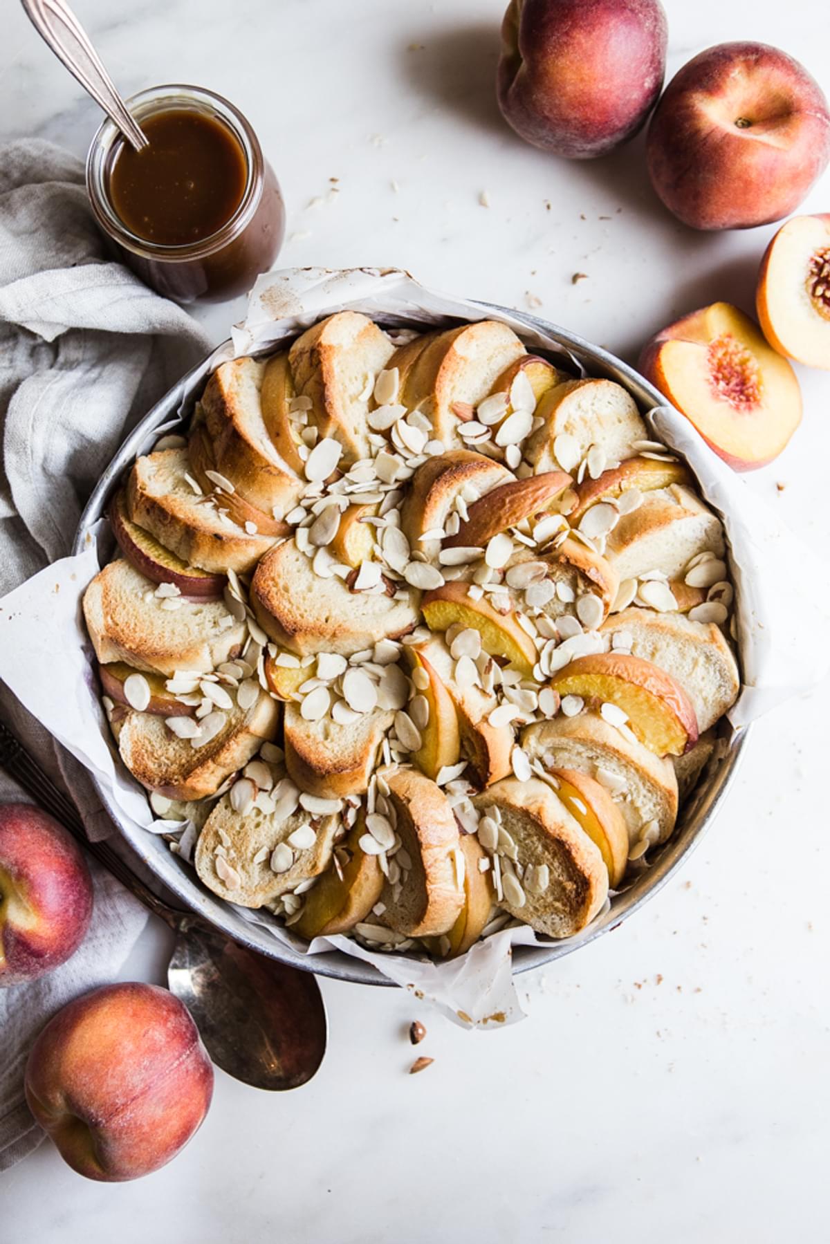 Almond Peach Bread Pudding with peaches and caramel sauce