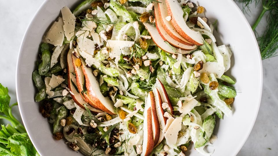 Celery Pear Salad with hazelnuts fennel and tarragon in a bowl