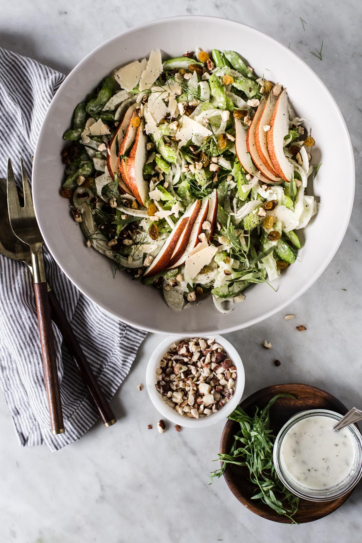 Celery Pear Salad with hazelnuts fennel and tarragon in a bowl