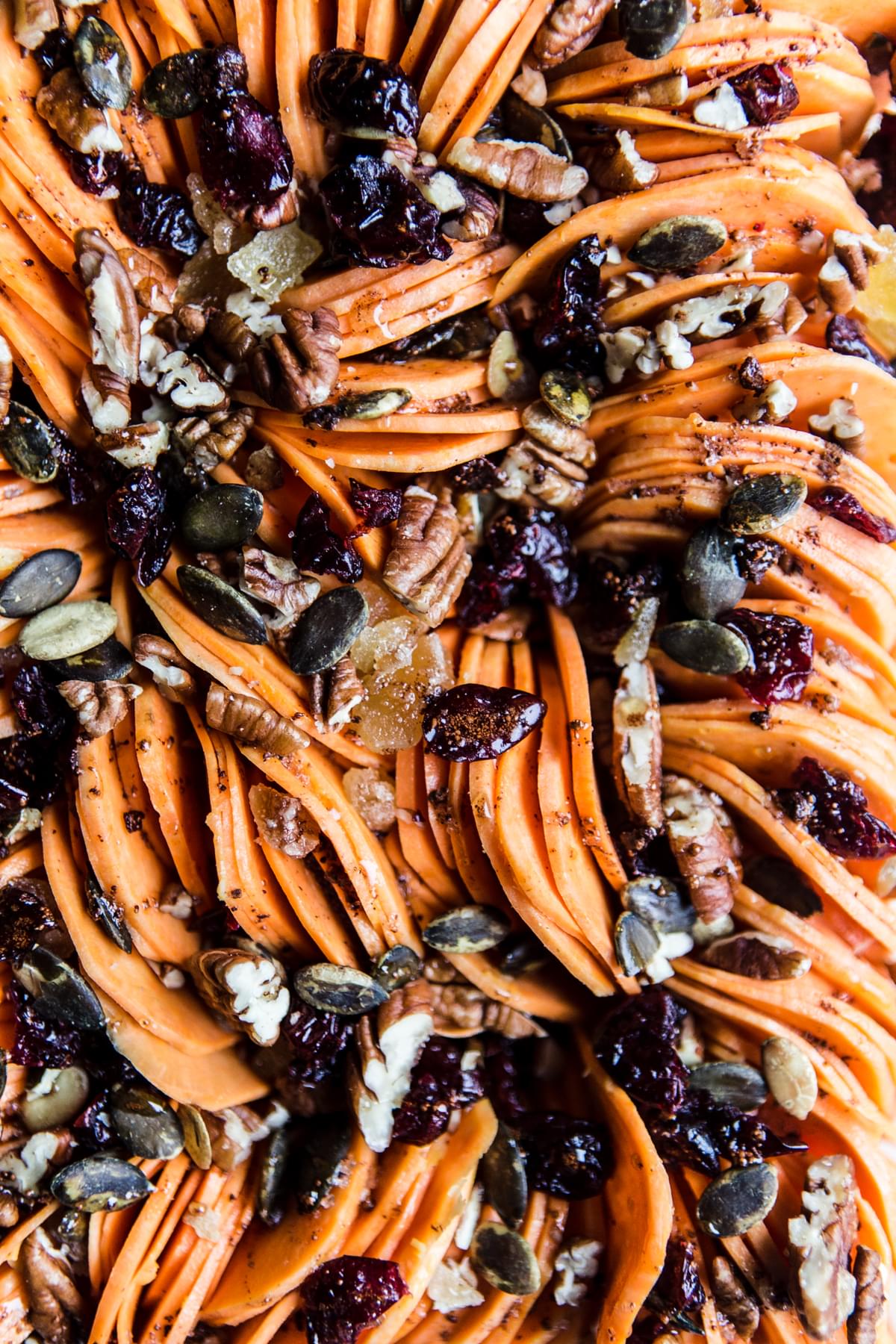 Healthy Sweet Potato Casserole in a baking dish made with cranberries, maple syrup, pecans and pumpkin seeds