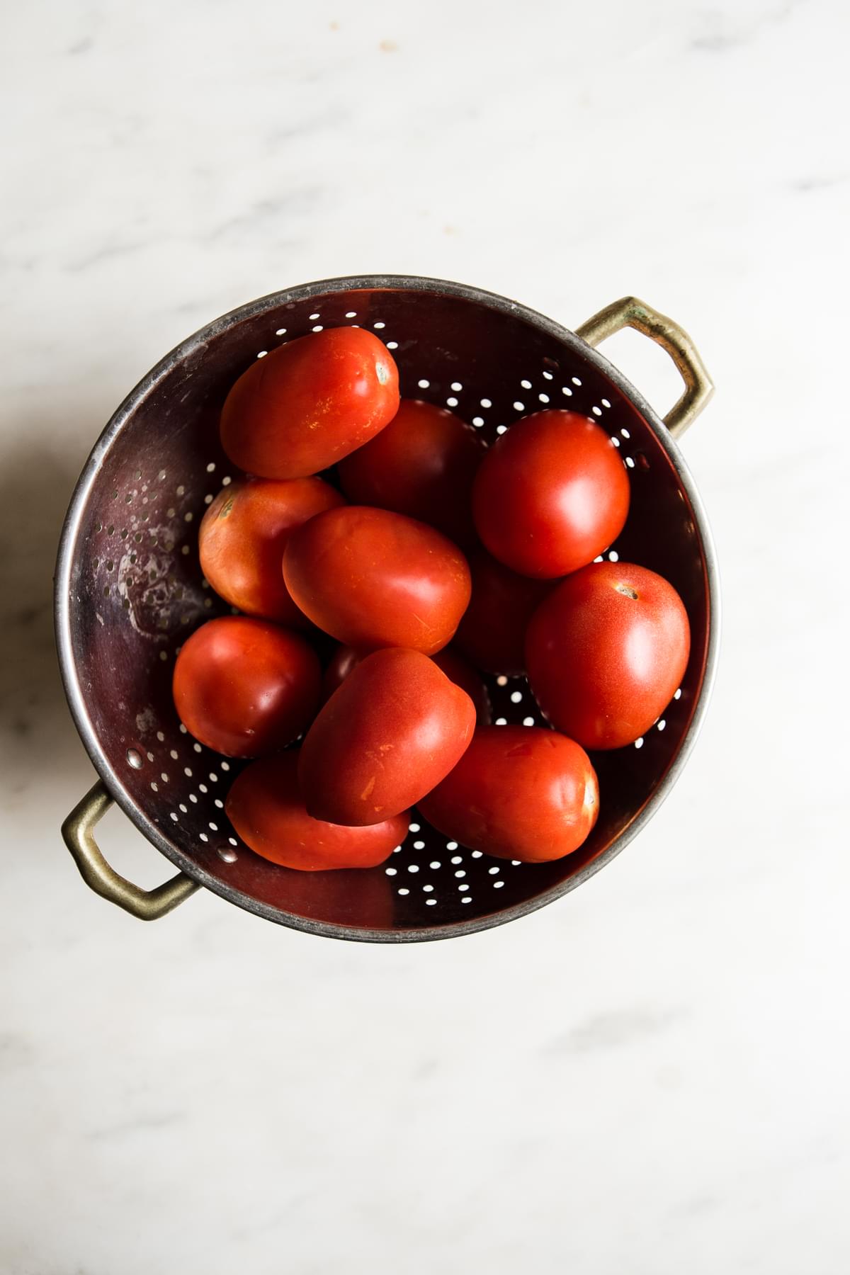 roma tomatoes in a colander