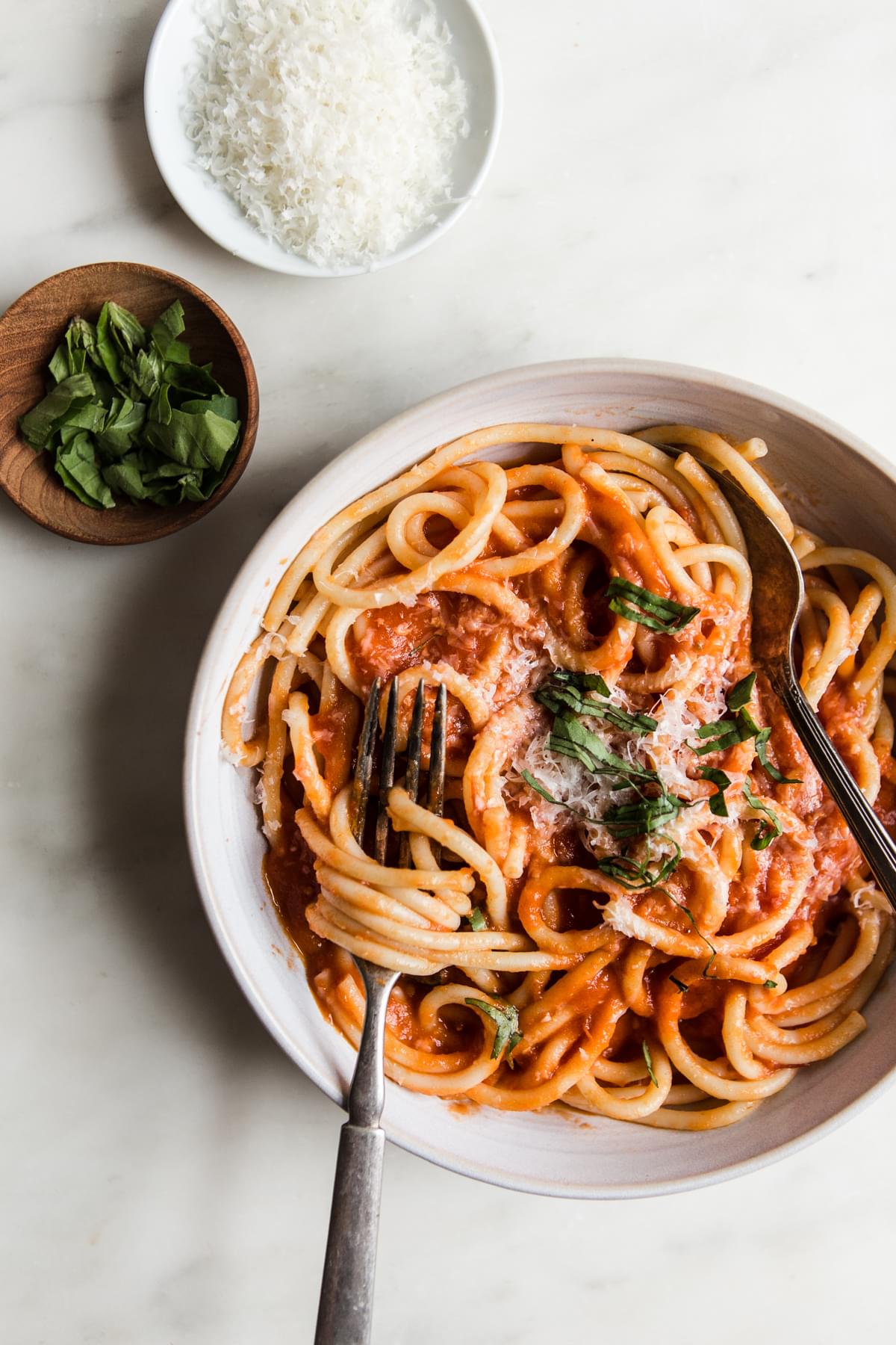 three ingredient tomato sauce with pasta, basil and parmesan cheese