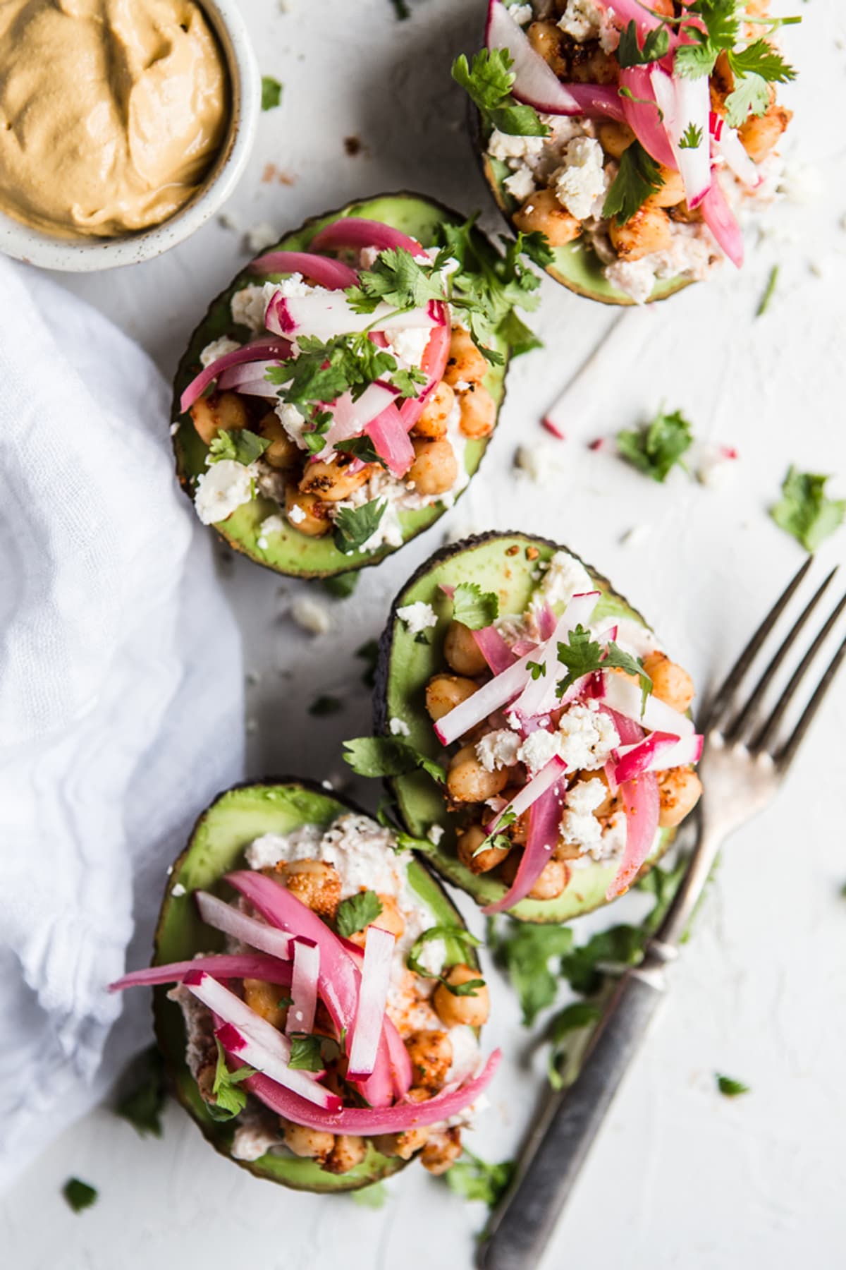 Tuna Salad And Chickpea Stuffed Avocado with pickled onions