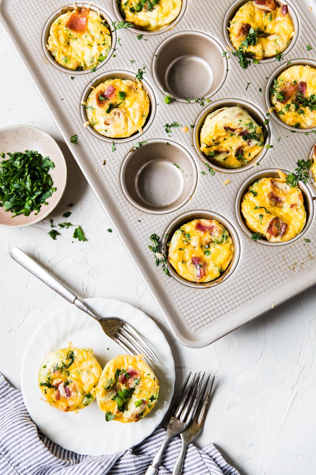 egg muffins with bacon, cheese and jalapeño in a muffin tin